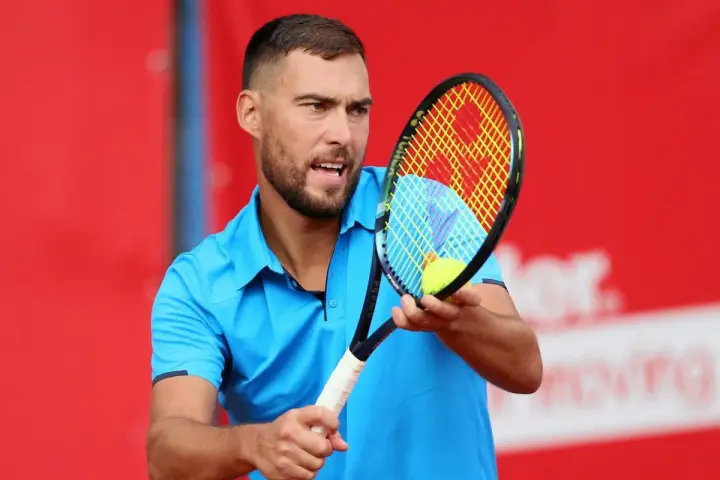Jerzy Janowicz, z rakietą i piłką, może symbolizować koniec kariery.